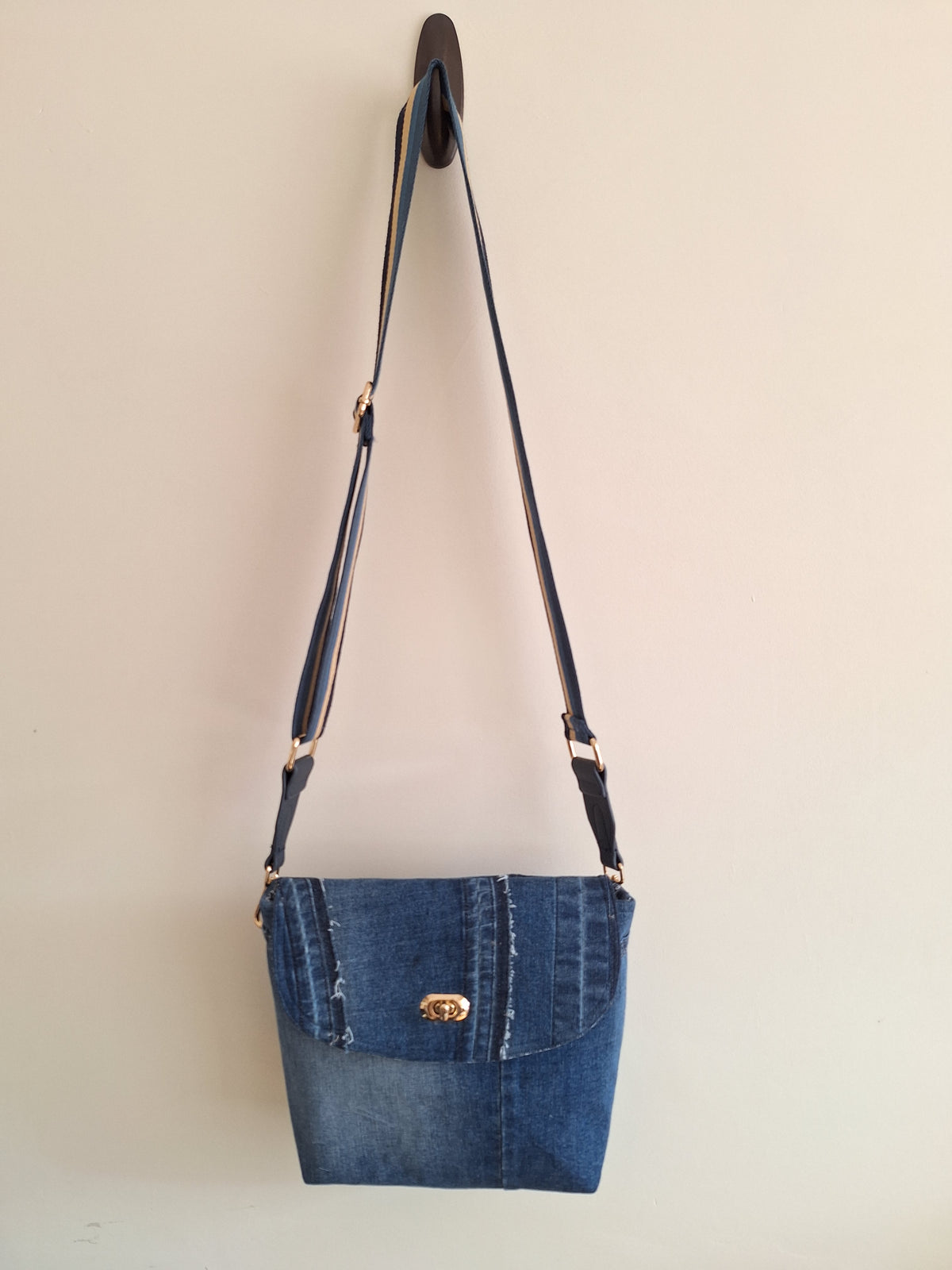 Denim crossbody bag with striped strap