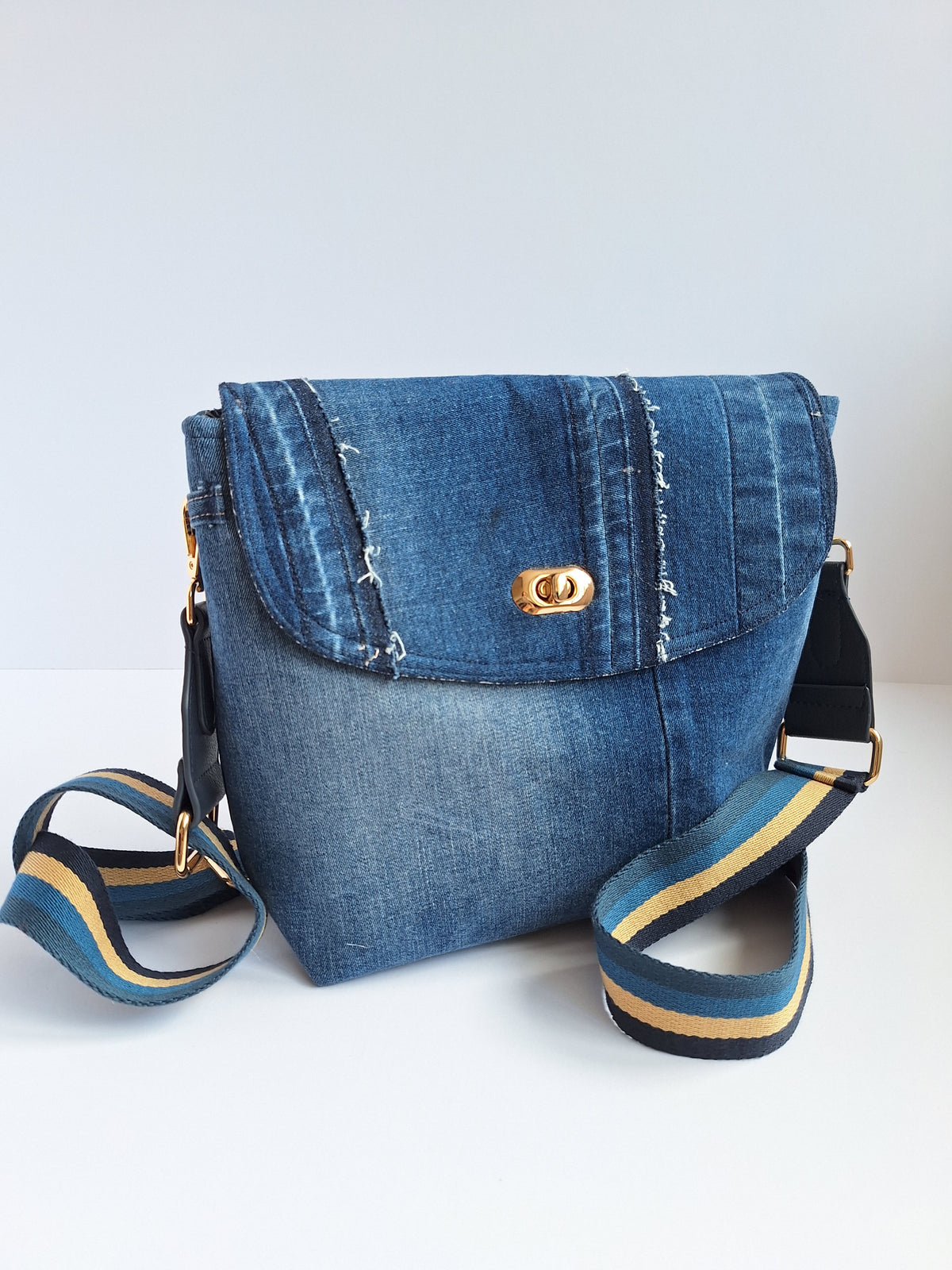 Denim crossbody bag with striped strap