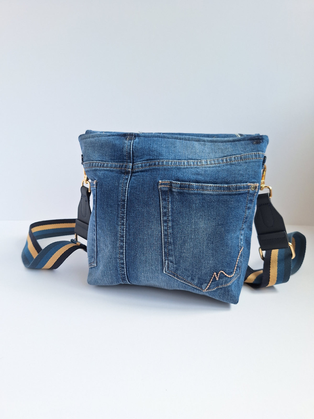 Denim crossbody bag with striped strap