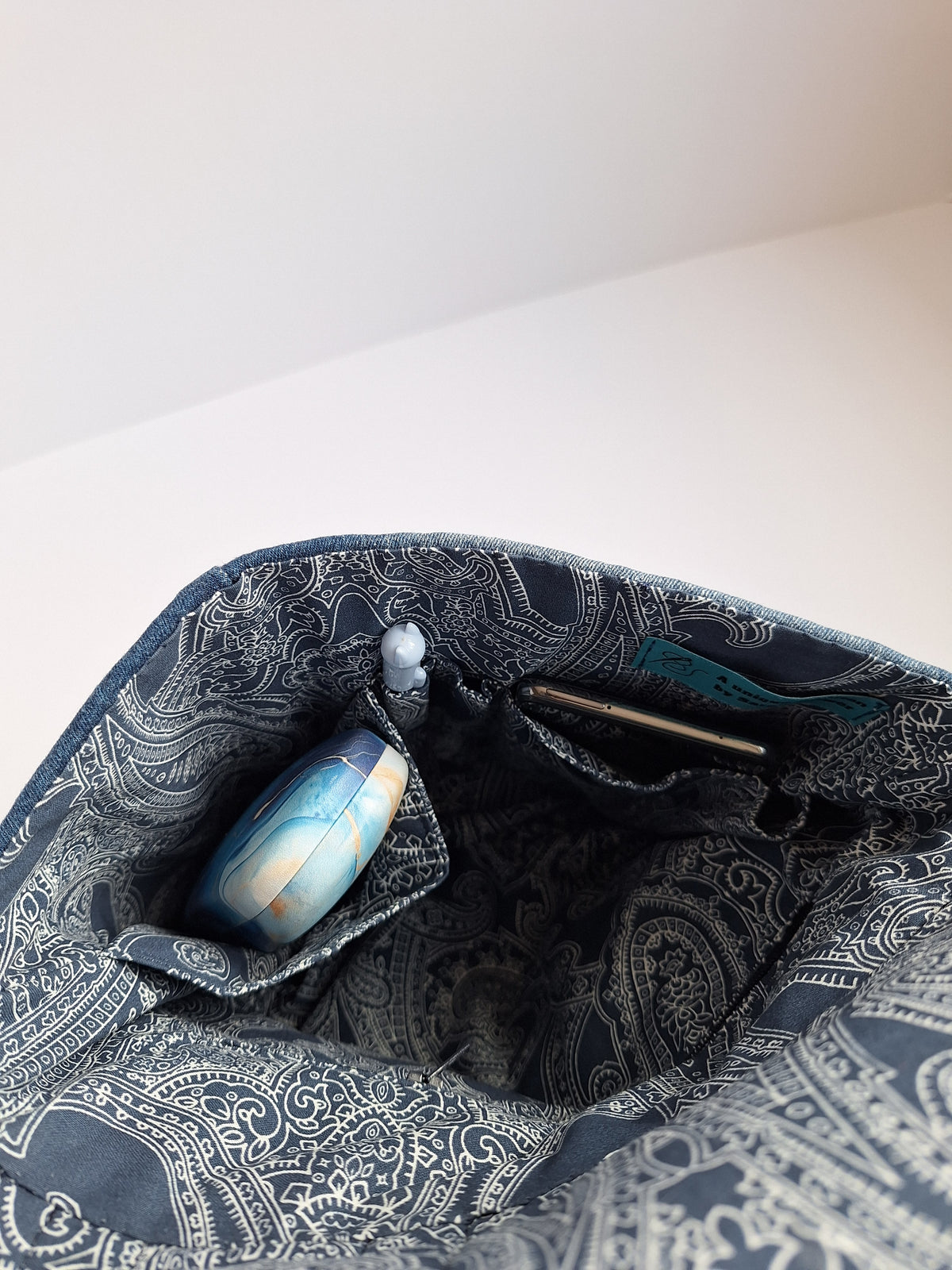 Denim crossbody bag with striped strap