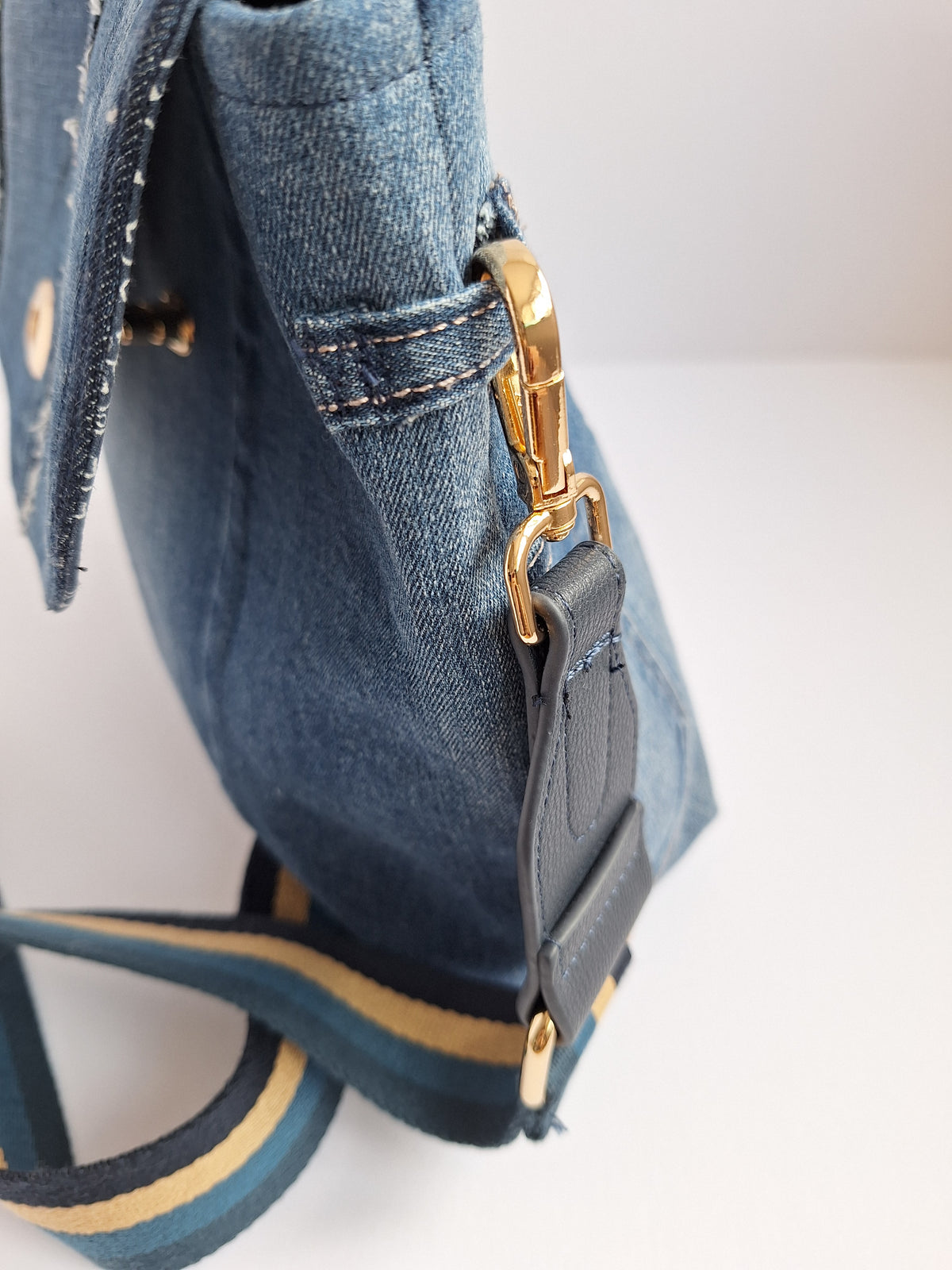 Denim crossbody bag with striped strap