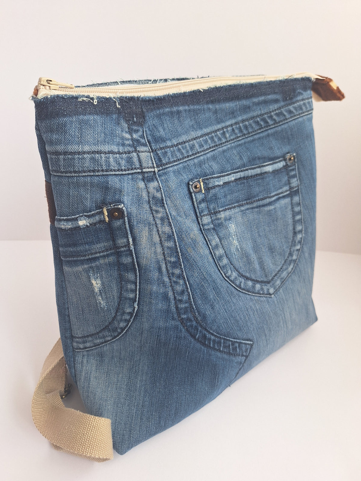 The Backpack: blue denim with giraffe print lining
