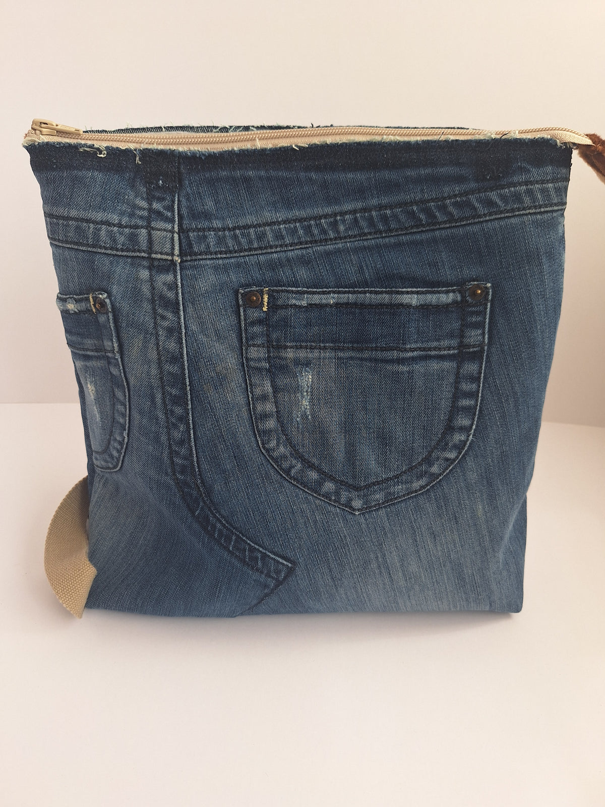 The Backpack: blue denim with giraffe print lining