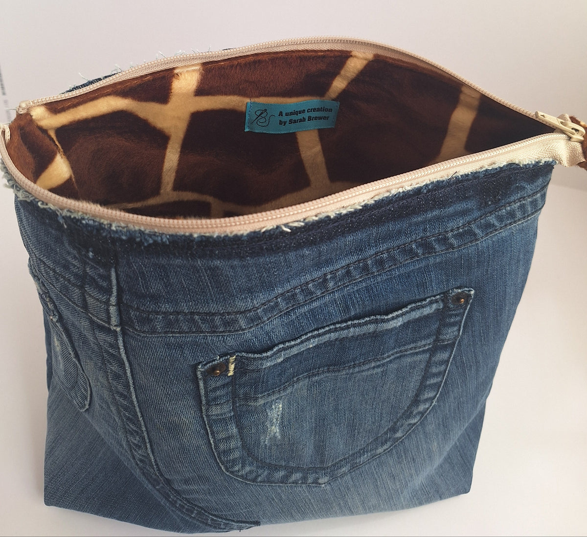The Backpack: blue denim with giraffe print lining